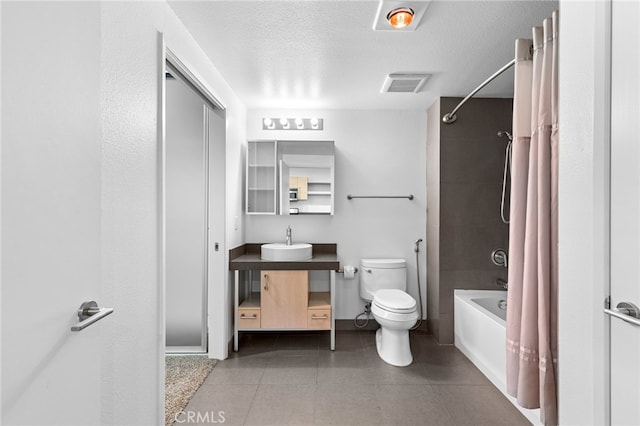 bathroom featuring a textured ceiling, visible vents, shower / bath combo, vanity, and toilet