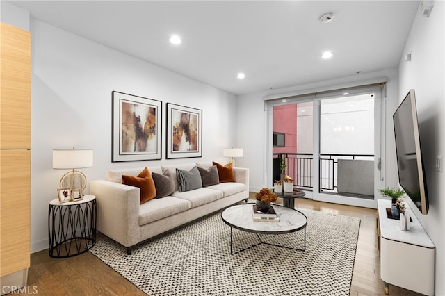 living room with recessed lighting, baseboards, and wood finished floors