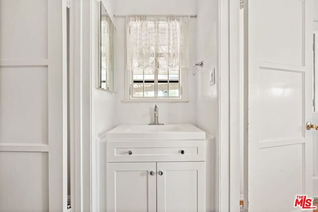 bar featuring sink and white cabinets