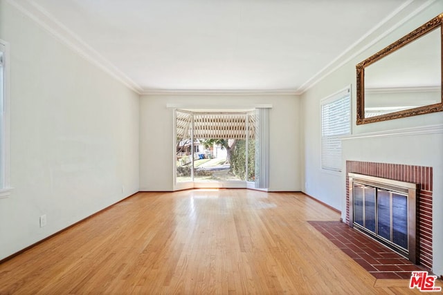 unfurnished living room with ornamental molding, hardwood / wood-style floors, and a fireplace