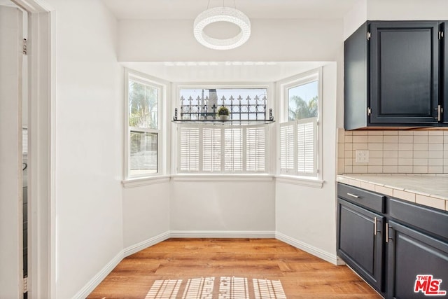 kitchen featuring decorative backsplash and light wood-type flooring