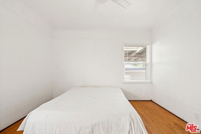 bedroom with hardwood / wood-style flooring and ceiling fan