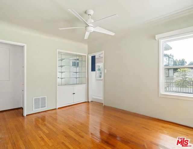 unfurnished bedroom with hardwood / wood-style floors and ceiling fan