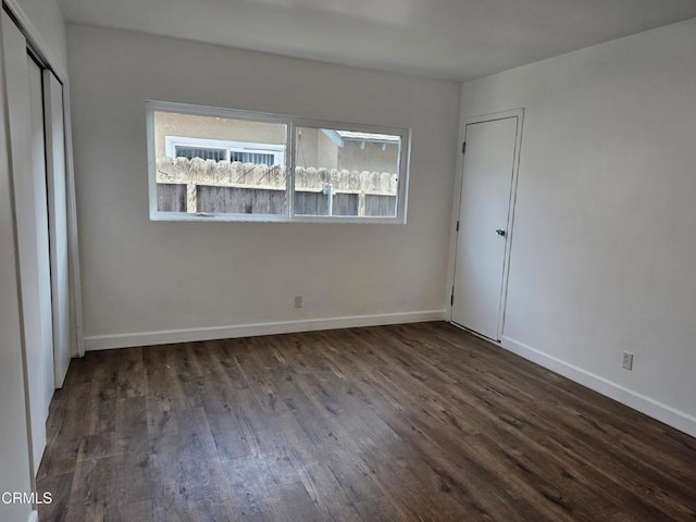 unfurnished bedroom featuring dark hardwood / wood-style flooring