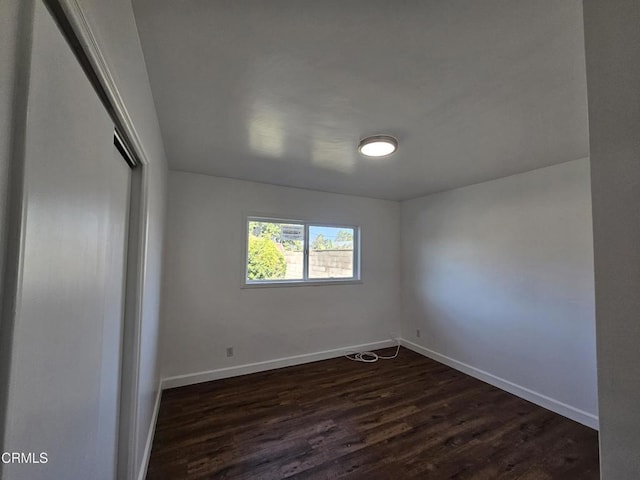 spare room featuring dark hardwood / wood-style flooring