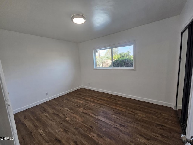 unfurnished room featuring dark hardwood / wood-style floors