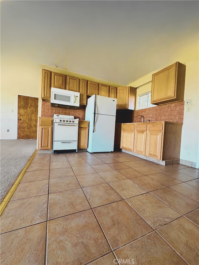 kitchen with light tile patterned floors, white appliances, and backsplash