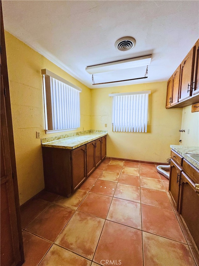 kitchen featuring plenty of natural light and light tile patterned floors