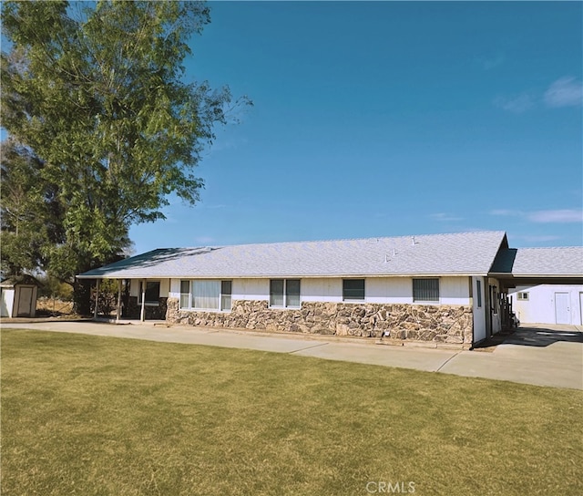 ranch-style house with a carport, a shed, and a front yard