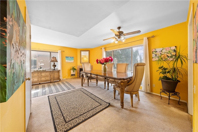 carpeted dining space featuring ceiling fan