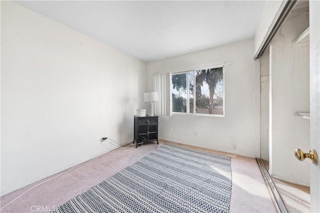 unfurnished bedroom with carpet flooring and a closet