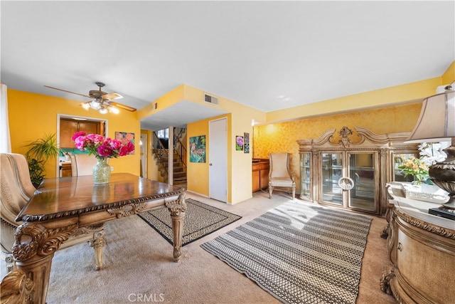 dining area featuring ceiling fan and light colored carpet