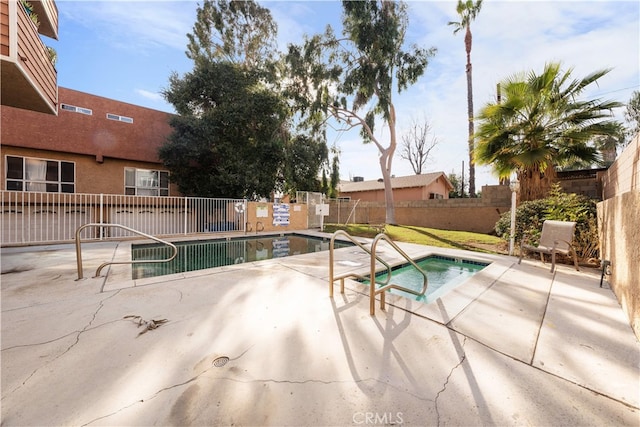 view of pool featuring a community hot tub and a patio area