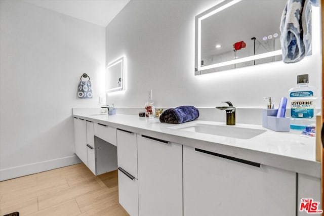 bathroom featuring vanity and hardwood / wood-style floors