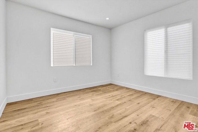 spare room with light hardwood / wood-style floors