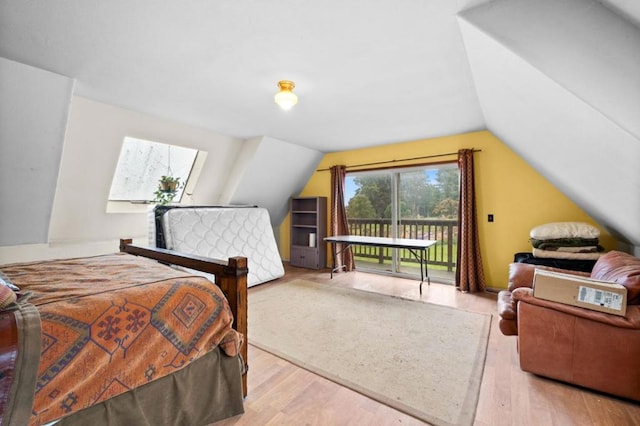 bedroom featuring vaulted ceiling, access to outside, and light wood-type flooring