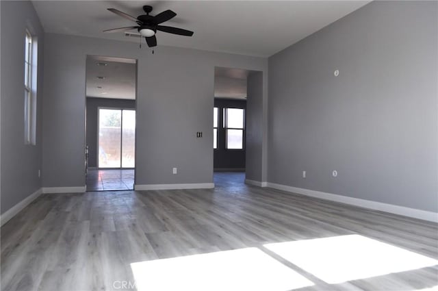 empty room featuring ceiling fan and light hardwood / wood-style flooring