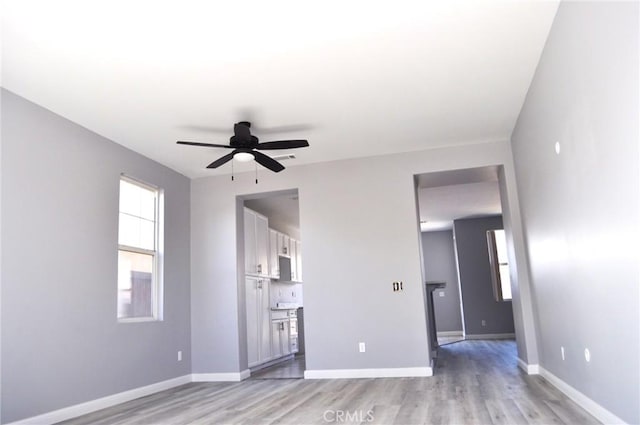 unfurnished living room with ceiling fan and light hardwood / wood-style flooring