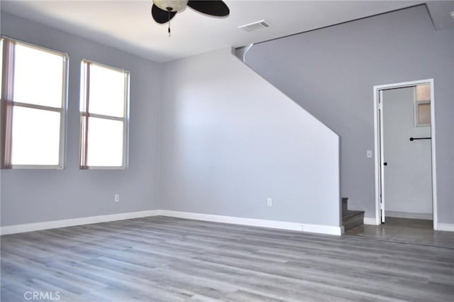 unfurnished living room with hardwood / wood-style flooring and ceiling fan