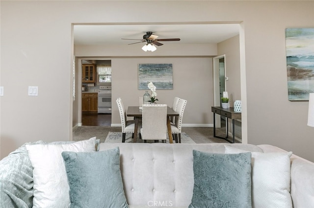 carpeted dining space featuring ceiling fan