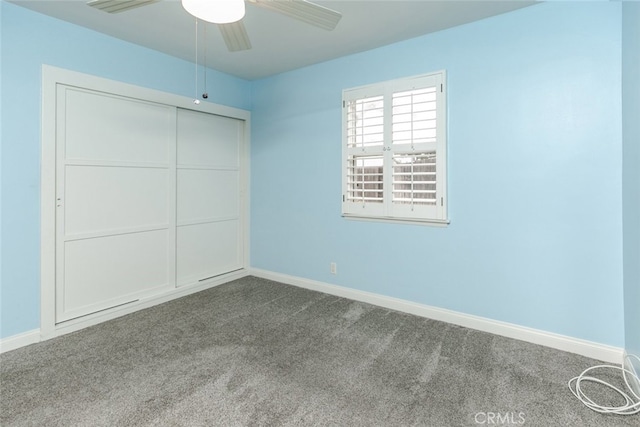 unfurnished bedroom featuring ceiling fan, a closet, and carpet