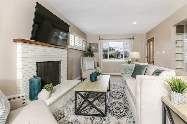 living room with a brick fireplace