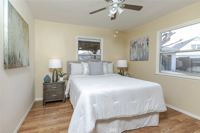 bedroom with light hardwood / wood-style floors and ceiling fan