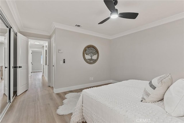 bedroom with crown molding, ceiling fan, and light wood-type flooring