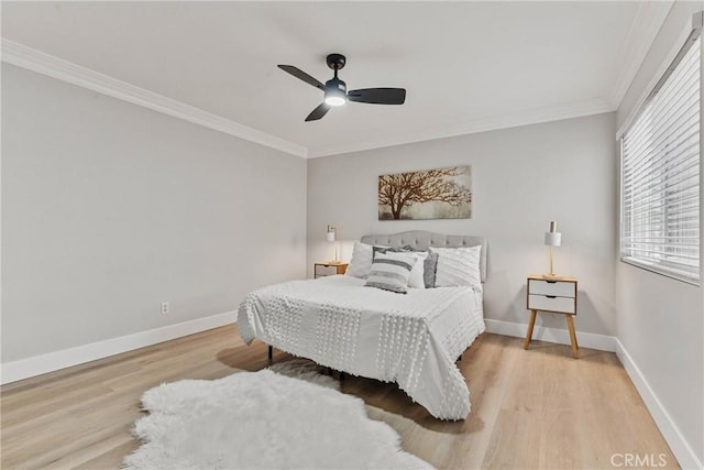 bedroom featuring crown molding, light hardwood / wood-style flooring, and ceiling fan