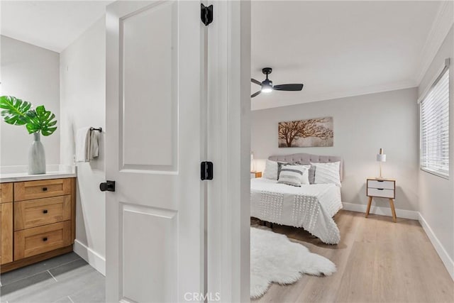 bedroom featuring ornamental molding and light wood-type flooring