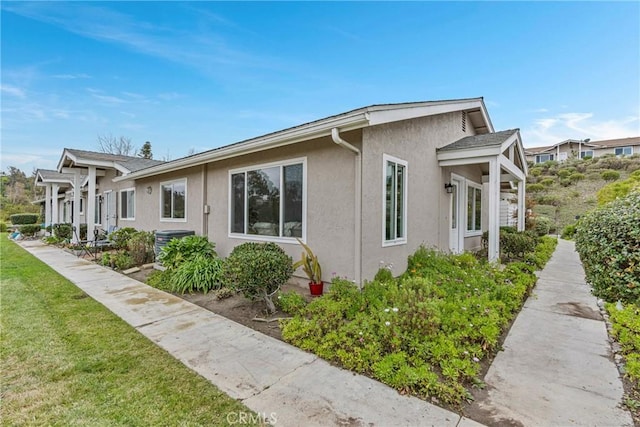 view of property exterior with a lawn