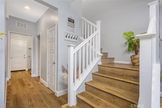 stairway with wood-type flooring