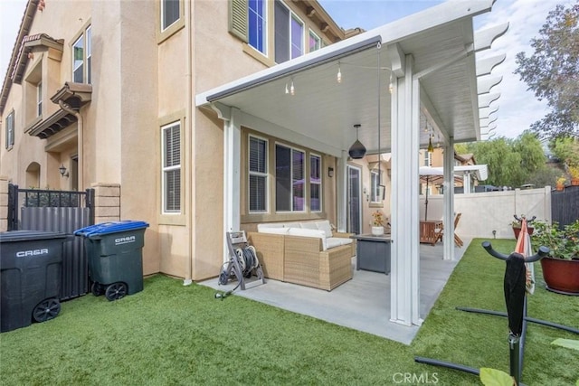 back of property with a yard, outdoor lounge area, and a patio