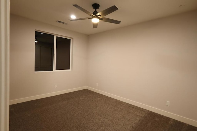 carpeted spare room with ceiling fan