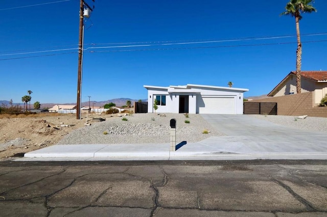 view of front of home with a garage and a mountain view