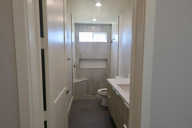 bathroom with vanity, a shower, tile patterned floors, and toilet