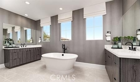 bathroom featuring vanity and a washtub