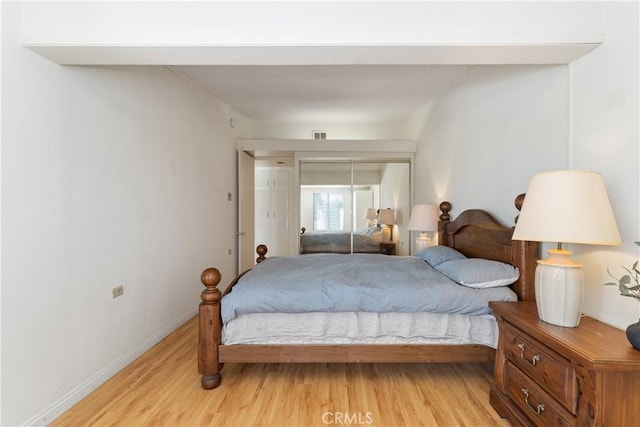 bedroom featuring light hardwood / wood-style floors and a closet