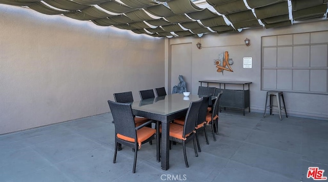 dining space featuring concrete floors