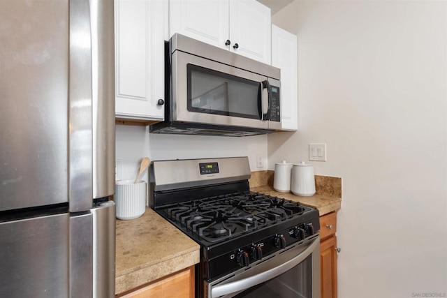 kitchen featuring appliances with stainless steel finishes and white cabinets