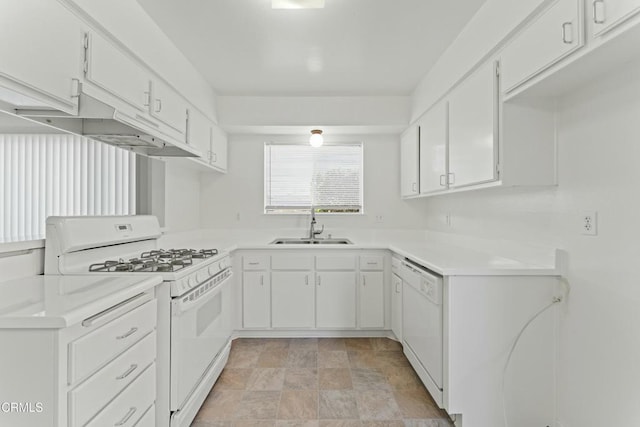 kitchen with white appliances, light countertops, white cabinets, stone finish floor, and a sink