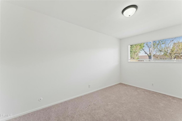 empty room with carpet flooring and baseboards