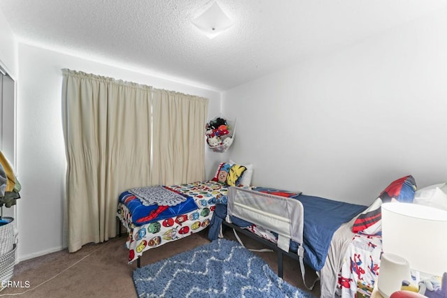 carpeted bedroom with a textured ceiling