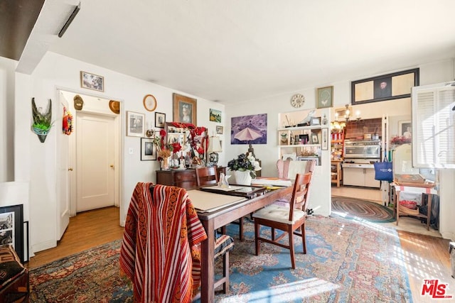 dining space featuring wood-type flooring