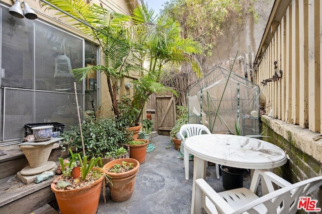 view of patio with an outbuilding