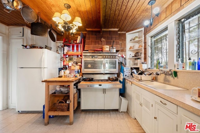 kitchen featuring sink, white cabinetry, decorative light fixtures, wooden ceiling, and white refrigerator