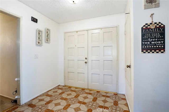 entryway with a textured ceiling