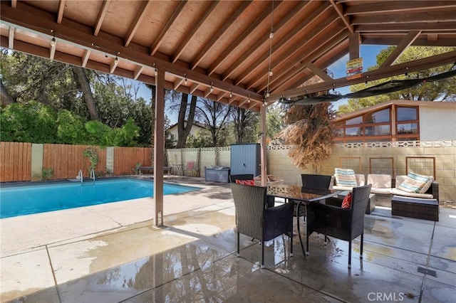 view of patio with outdoor lounge area and a fenced in pool