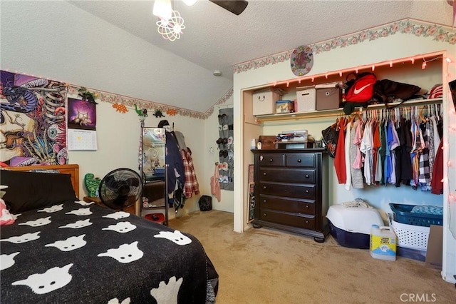 carpeted bedroom with lofted ceiling, ceiling fan, and a textured ceiling