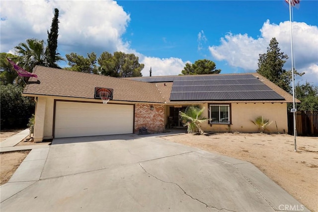 single story home featuring a garage and solar panels